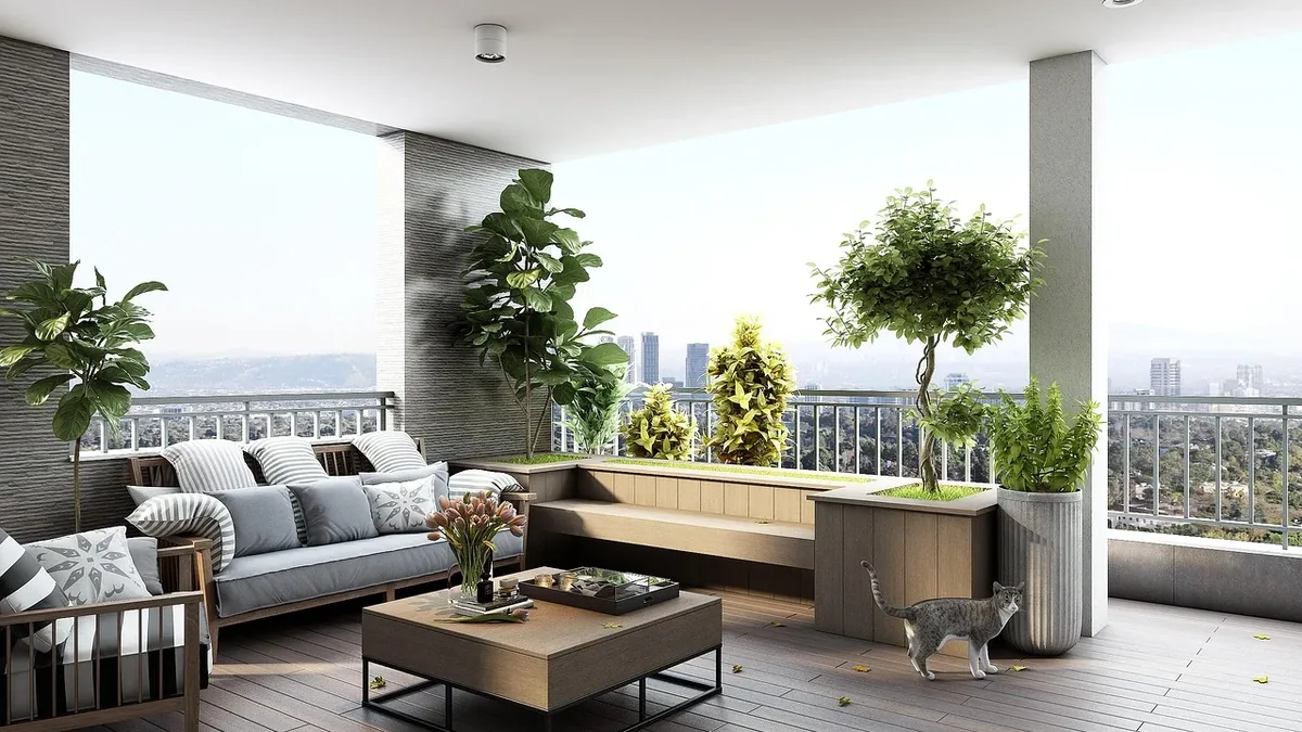 A modern, open-plan living space with a balcony, featuring a couch, coffee table, and potted plants, with a cityscape visible in the backgro